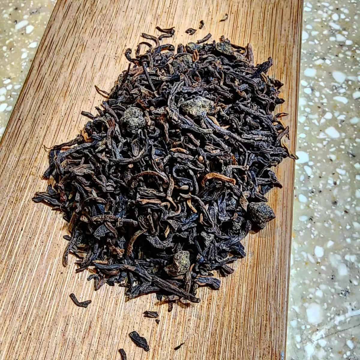 Dried loose tea leaves on a woody table