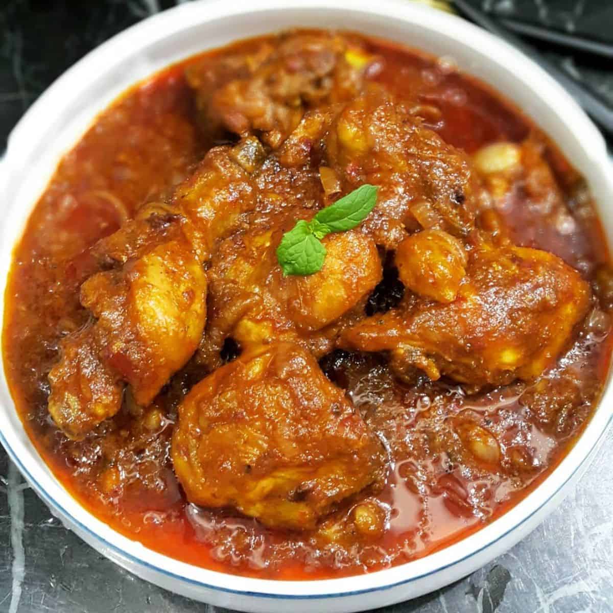 Sambal Chicken recipe in a white bowl with appetising colour.