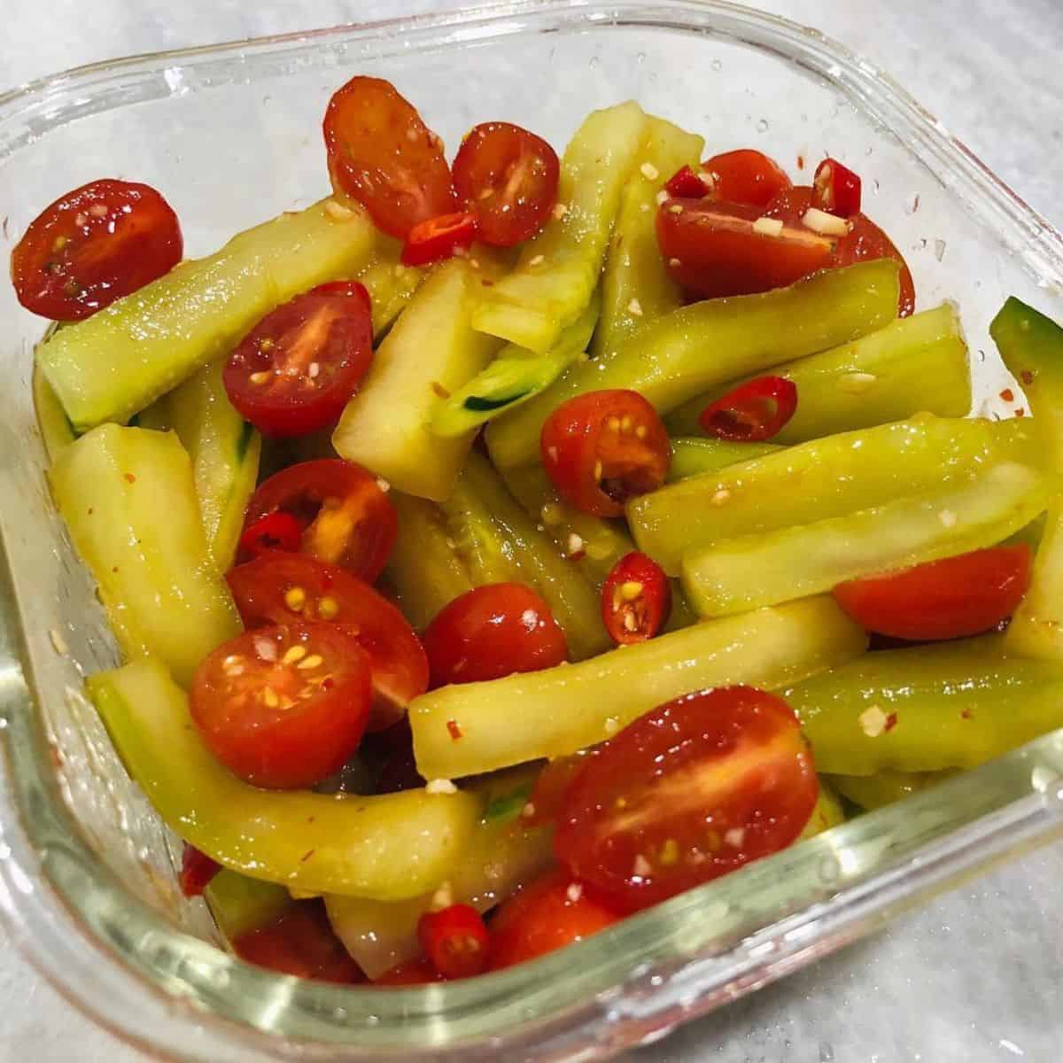Delicious slices of green veggie with cherry tomatoes